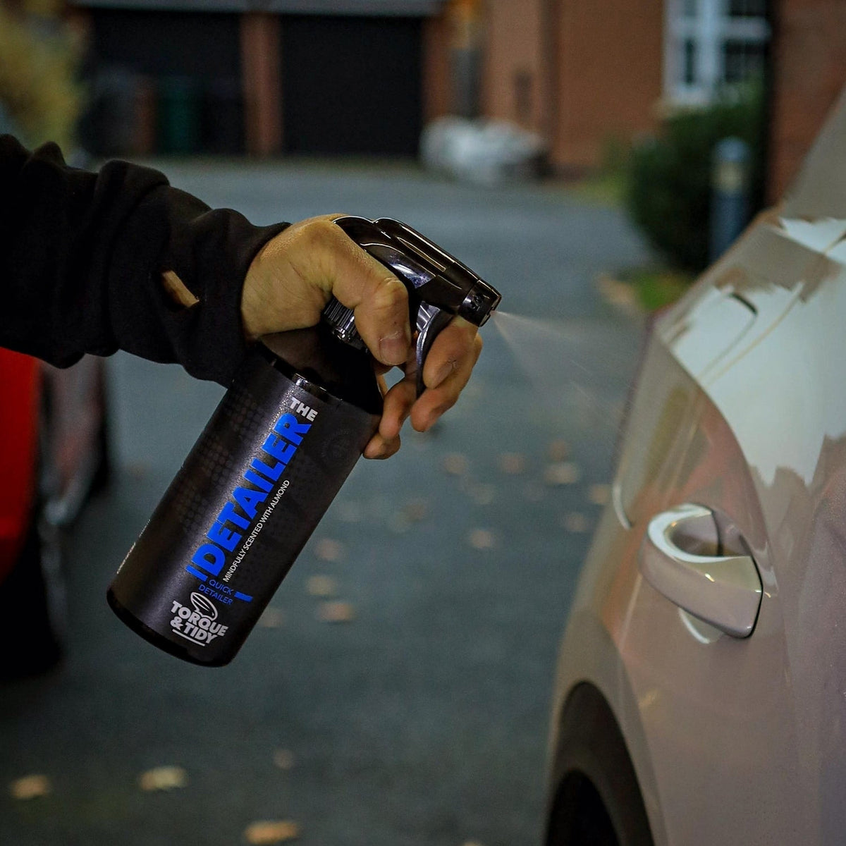 Spraying The Detailer onto a car's paintwork