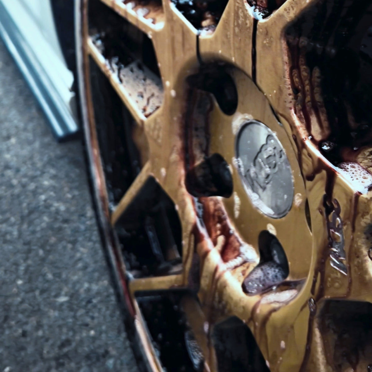 Wheel cleaner turning red as it works on a bronze alloy wheel