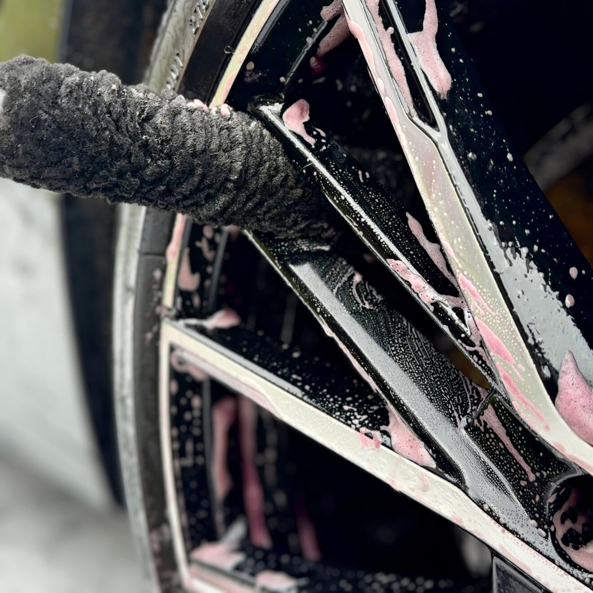 The Small Wheel Wand cleaning between the spokes of a wheel