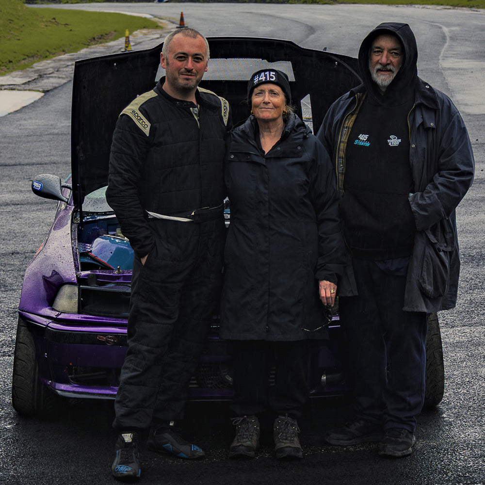 Jamie Stanton and supporters at the purple #415 drift car, bonnet up