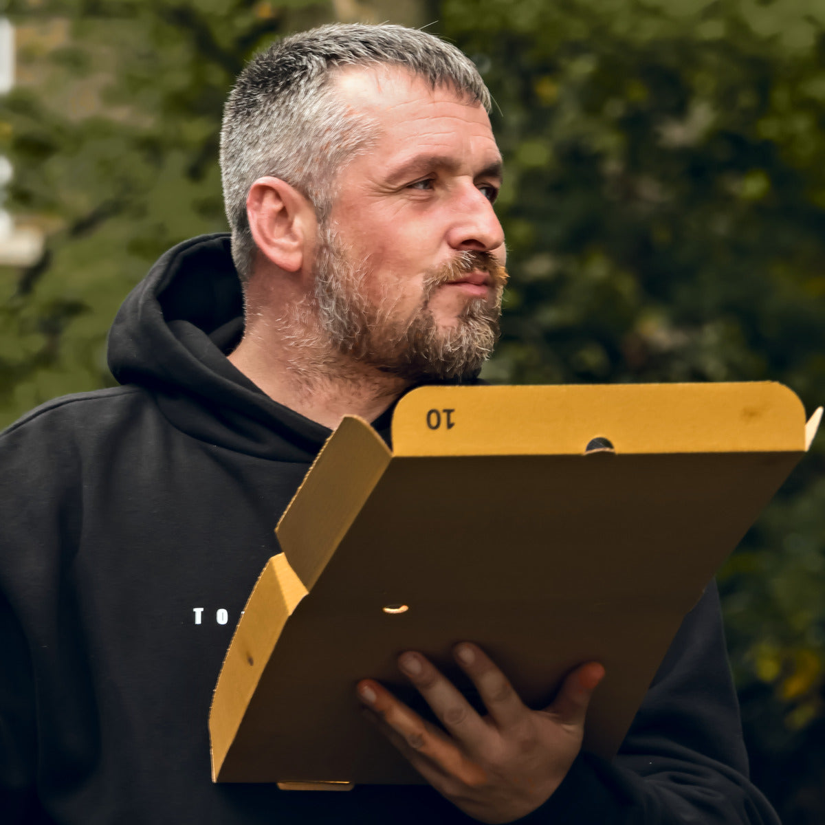 A member of the Torque & Tidy team in a T&T hoodie