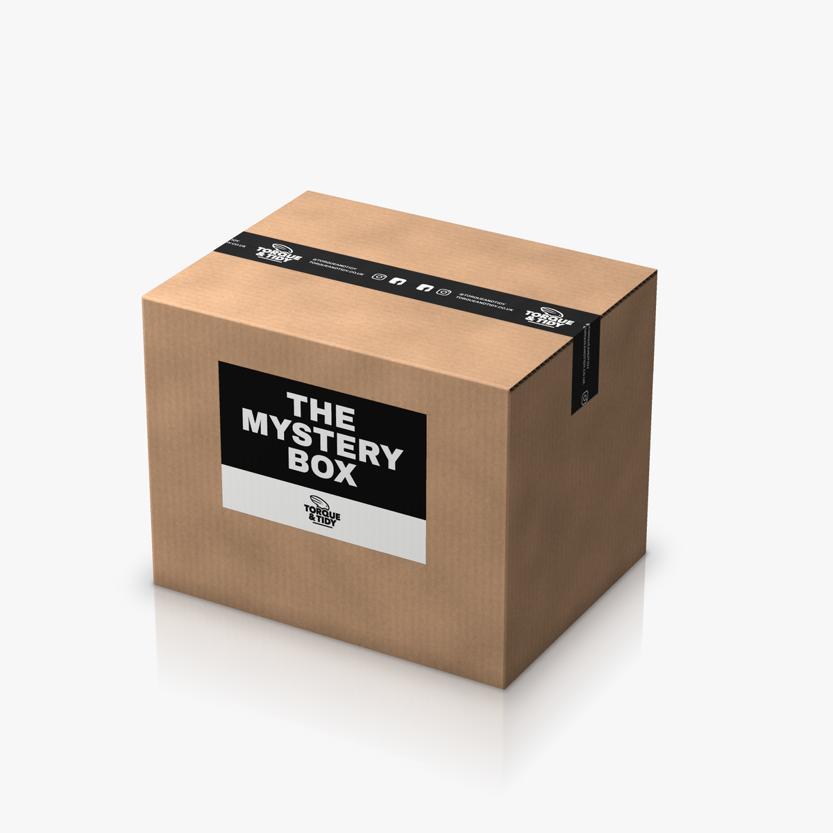 The Mystery Box: a brown cardboard box with The Mystery Box label, sealed with black Torque & Tidy tape