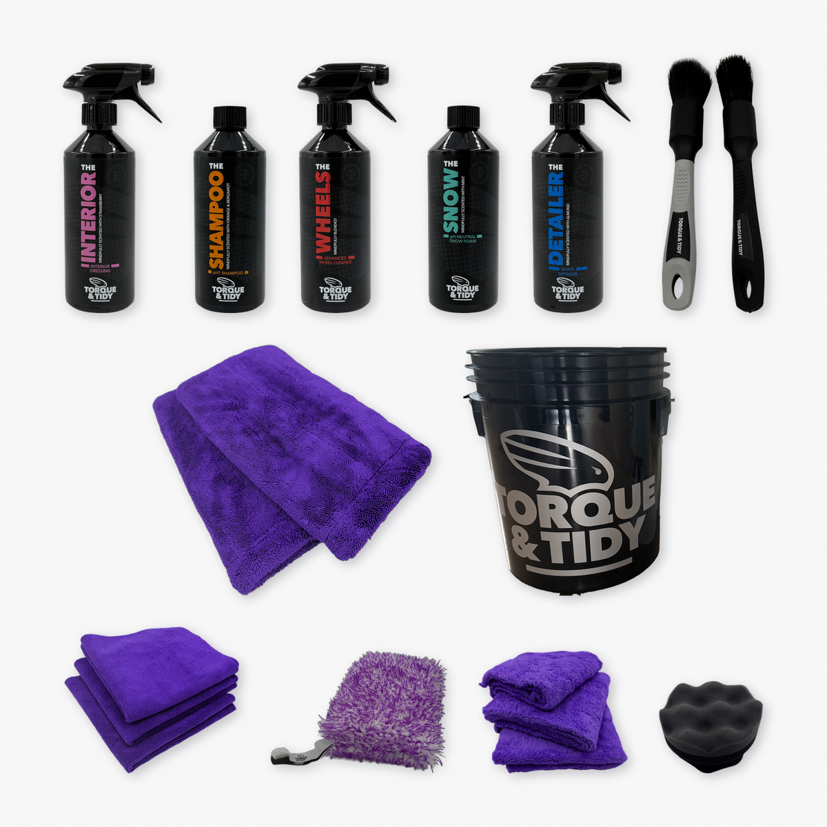 What's inside The Starter Bundle in Purple: five bottles, black Wash Bucket, purple Dry Towel and GP Cloths, Buff Cloths, purple wash pad, brushes and tyre applicator laid out