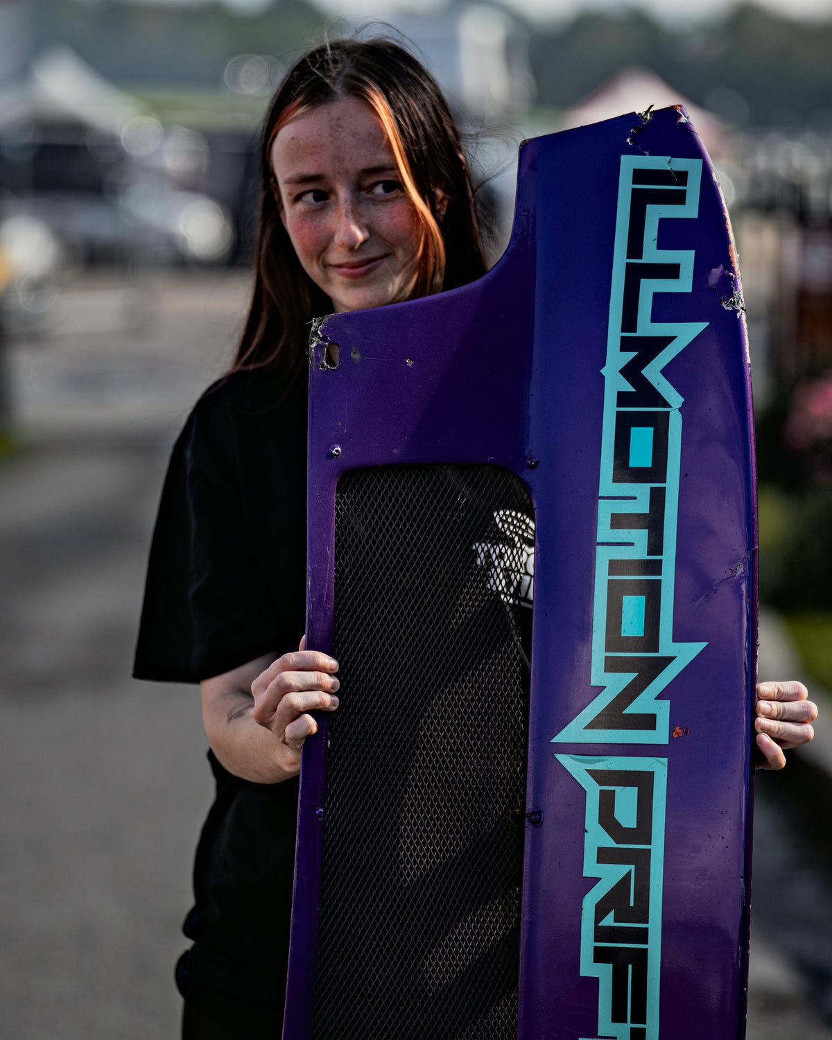 Holding a purple drift car body panel in the Drift League GB paddock