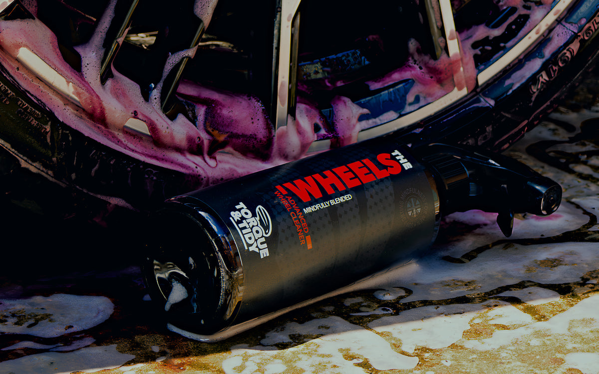 The Wheels beside an alloy wheel as the cleaner turns purple