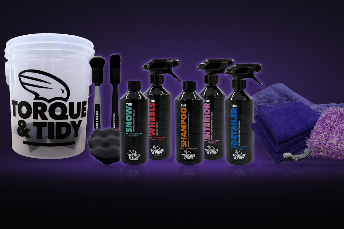 The Starter Bundle: wash bucket, brushes, wash pad, cloths and bottles on a dark purple background