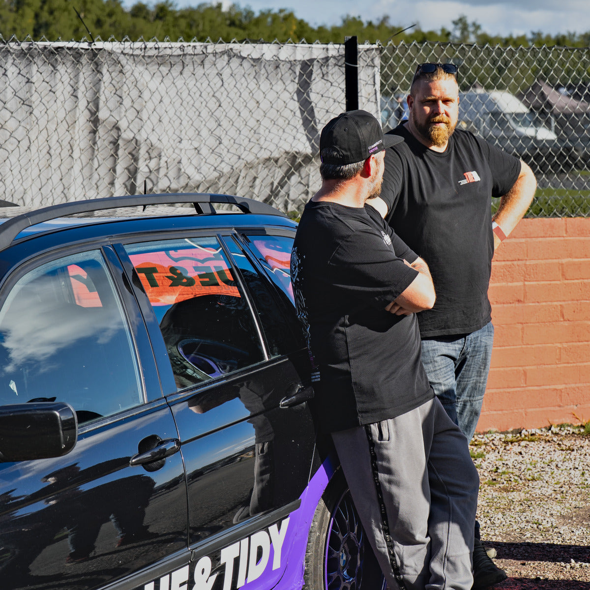 Two of the Torque & Tidy team chatting by the T&T car