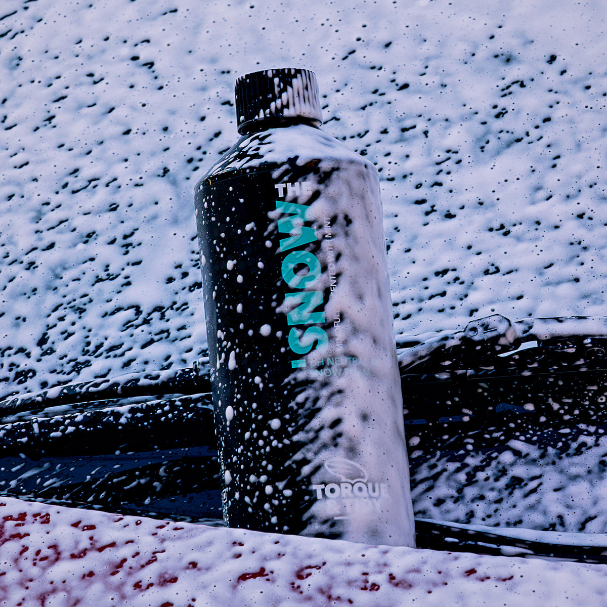The Snow standing in snow foam on a windscreen